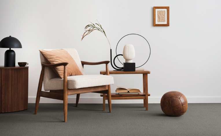 gray carpet flooring in mid century modern living room with wood furniture